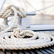 Mooring rope with a knotted end tied around a cleat.