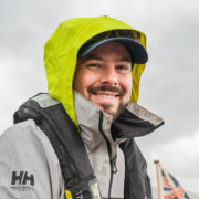 Christoph, founder of NOMADS.insure and passionate sailor, here in sailing gear somewhere offshore