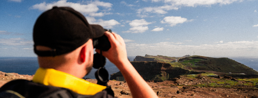 Christoph looking at the stunning landscape of Madeira island with binoculars