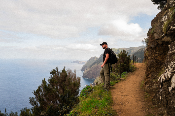 Christoph standing next to a hiking path by the sea on Madeira island