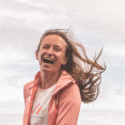 A girl laughing while the wind blows through her hair