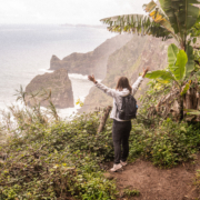 Female Digital Nomad spreading her arms at a stunning ocean view on Madeira island