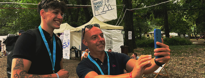 Aaron Schnakenberg and James Meads taking a selfie together at the Bansko Nomad Fest 2024
