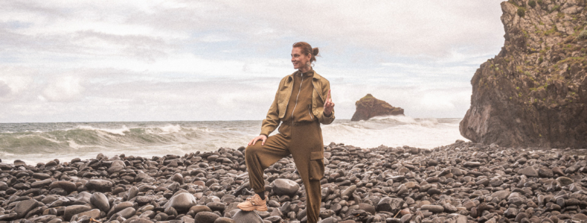 Female Digital Nomad on a pebble beach
